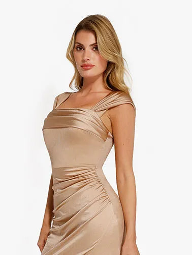 A model wearing a champagne-colored shapewear dress with a square neckline and draped detailing